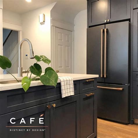 The moody dark cabinetry and matte black Café appliances are just ...