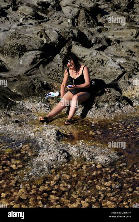 Old Woman In Bikini On The Rocks Stock Photo Alamy