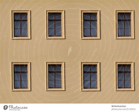 Beige House Facade With Eight Wooden Windows A Royalty Free Stock