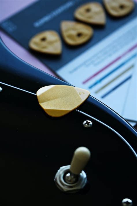 Close-Up Photo of Guitar Pick on Black Surface · Free Stock Photo