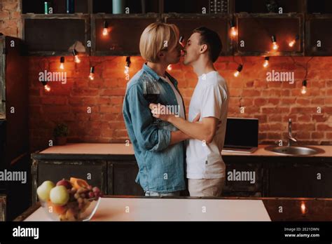 Loving Gay Couple At Home Two Handsome Men Hugging And Kissing On