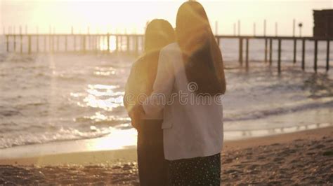 Photographer Takes Pictures An Adult Daughter Hugs Her Mother At Sunset