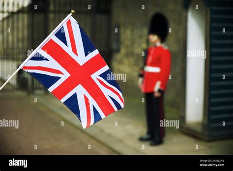 British Union Jack Flag Flying In Front Of Unrecognizable Royal Guard