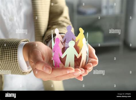 Woman Holding Paper Human Figures On Blurred Background Closeup