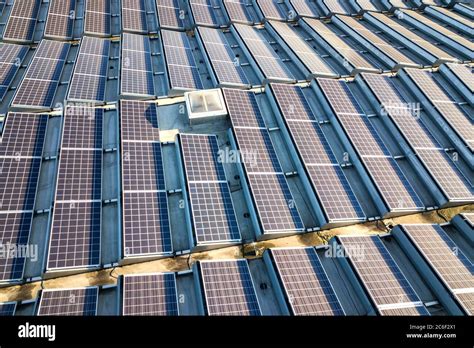 Aerial View Of Many Photo Voltaic Solar Panels Mounted Of Industrial