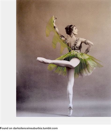 A Woman In A Green Tutu Is Posing For The Camera With Her Arms Outstretched