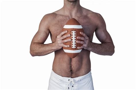 Premium Photo Midsection Of Shirtless Rugby Player Holding Ball