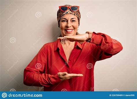 Middle Age Brunette Woman Wearing Handkerchief On Head And Shirt Over