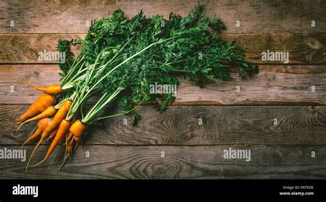 Fresh Organic Carrots With Green Leaves On Wooden Background Vegetables Healthy Food Top View