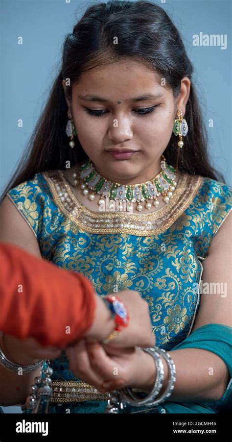 Sister Tying The Rakhi Raksha Bandhan To Brothers Wrist During