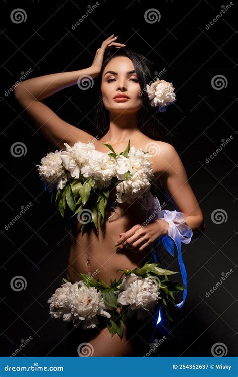 Sensual Naked Lady With White Flowers On Body Standing In Dark Studio