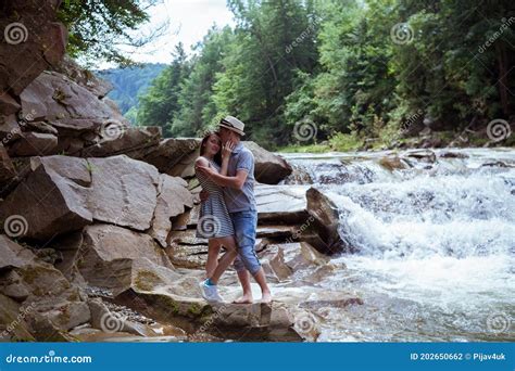 Couple Hugging And Kissing Near Waterfalls Stock Photo Image Of