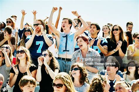 Crowd Of Football Fans Celebrating During Game High Res Stock Photo