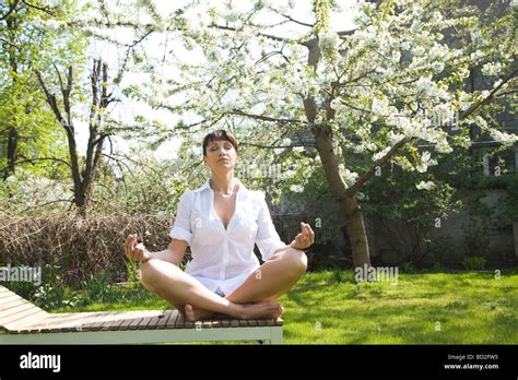 Mature Woman Relaxing In Garden Stock Photo Alamy