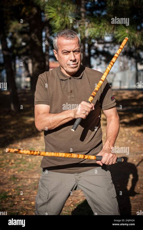 Escrima And Kapap Instructor Demonstrates Sticks Fighting Techniques In