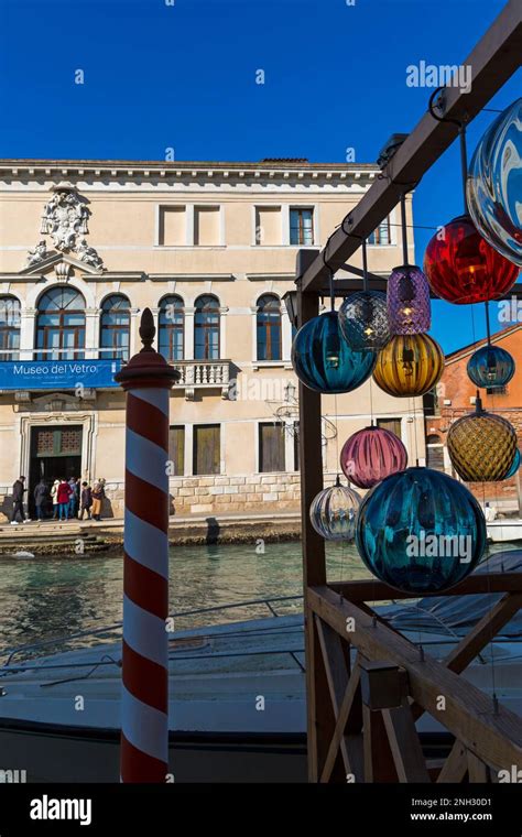 Murano glass lights with reflections hanging opposite Museo del Vetro Murano Glass Museum at ...