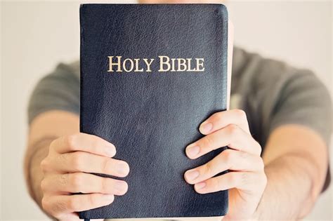 Premium Photo Close Up Of Person Hand Holding Bible