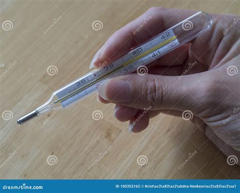 Woman Hand Holding Mercury Clinical Thermometer Showing High Fever