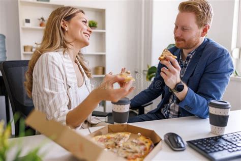 Business Colleagues Taking A Lunch Break At The Office Stock Photo