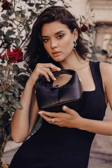 Beautiful Woman With Dark Hair In Elegant Black Dress And Accessories