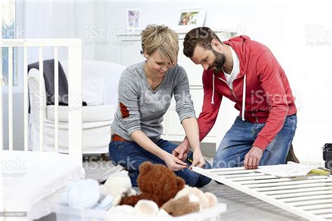 Happy Young Couple Fixing Baby Crib Stock Photo Download Image Now