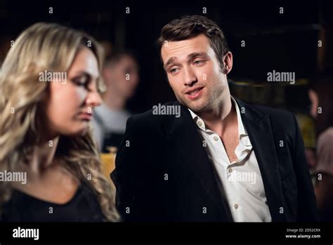 A Man Meets A Beautiful Blonde At The Bar Stock Photo Alamy
