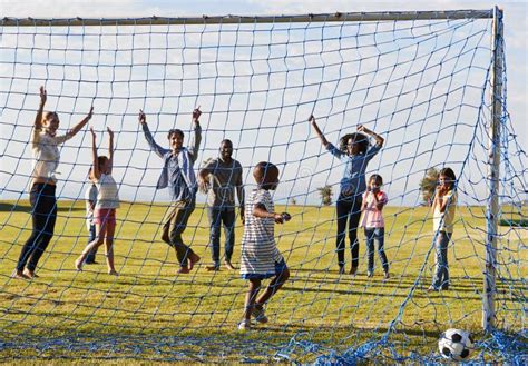 Two Families Playing Football in Park Celebrating a Goal Stock Image ...