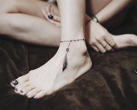 Ankle Band With A Feather Tattoo Feather Tattoos Feather Tattoo Design Anklet Tattoos For Women