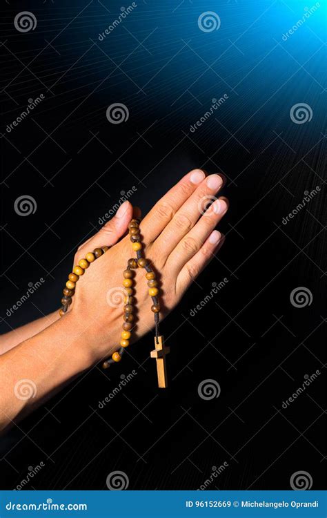 Praying Hands Holding Rosary Beads On Black Background Stock Image