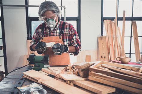 Carpenter Working On Woodworking Machines In Carpentry Shop Stock Photo