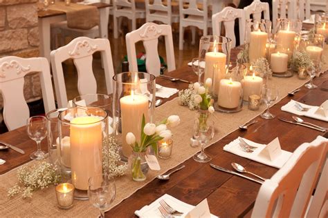 The Long Tables Will Have Pillar Candles In Vases At Varied Heights With Clear Bud Vases With