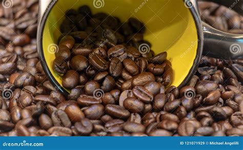 Coffee Beans Spilling From Yellow Ceramic Cup Stock Image Image Of