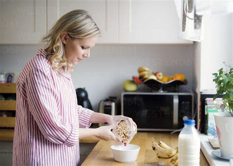 Woman Preparing Breakfast In The Kitchen At Home Stock Photo