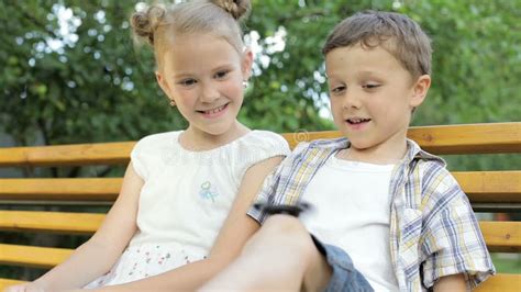 Happy Children Sitting On Bench Stock Footage Video Of Beautiful