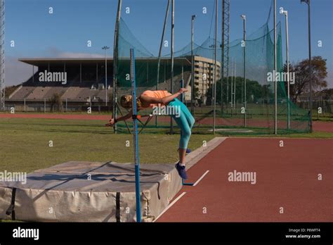 Female athlete practicing high jump Stock Photo - Alamy