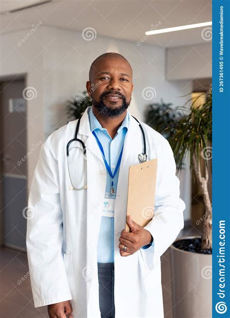 Vertical Portrait Of Happy African American Male Doctor In Hospital