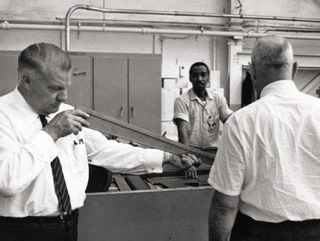 Black And White Photograph Of Two Men Working In A Factory One Man Is