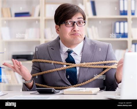 The Businessman Tied Up With Rope In Office Stock Photo Alamy