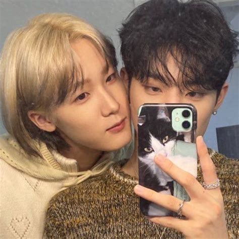 A Man And Woman Taking A Selfie With Their Cell Phones In Front Of Them