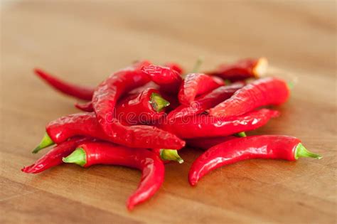 Red Hot Chili Peppers Indoors On A Wooden Cutting Board Stock Image Image Of Chili Plant
