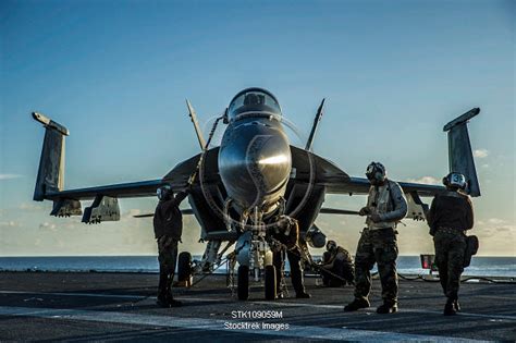 Sailors Perform Post Flight Procedures On An F A 18E Super Hornet