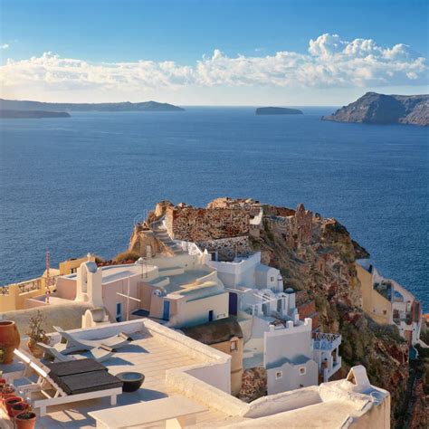 Typical Architecture And Castle Ruins In Oia Santorini Greece Stock