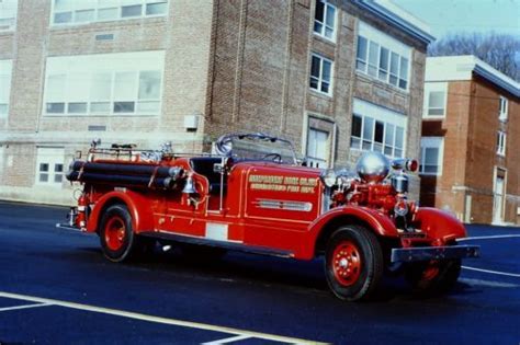 An Old Fire Truck Parked In Front Of A Brick Building