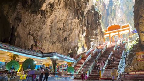 Tourists Climb The Stairs To Batu Cave In Kuala Lumpur Near The Golden