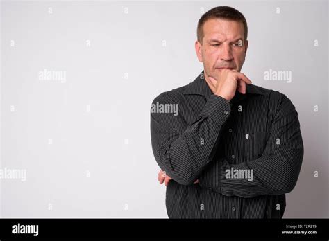 Studio Shot Of Macho Mature Businessman Looking Strong And Muscular