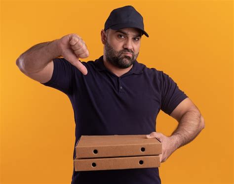 Free Photo Unpleased Middle Aged Delivery Man In Uniform And Cap