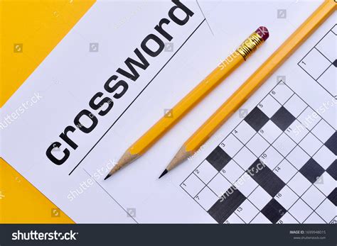 Crossword Puzzle Pencils On Yellow Background Stock Photo 1699948015