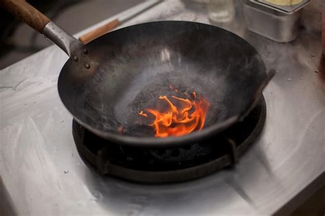 Premium Photo Fire In The Pan Professional Chef In A Commercial Kitchen Cooking Flambe Style