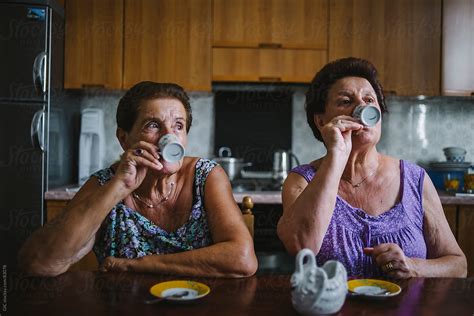 Two Seniors Women Drinking Coffee By Stocksy Contributor Simone Wave