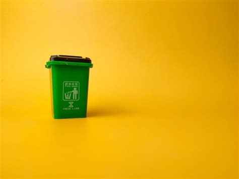Premium Photo | Mini Waste Bin on a yellow background